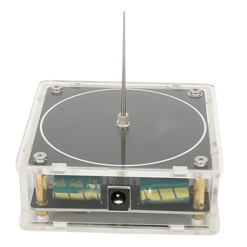 A clear plastic box containing an arc plasma music coil for educational experiments with a central metal rod.