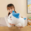 A white and blue Chiikawa Hachiware plush pillow is held by a person in a bright indoor setting.