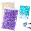 Bag of purple resin rhinestones and a bag of gold resin rhinestones with tweezers