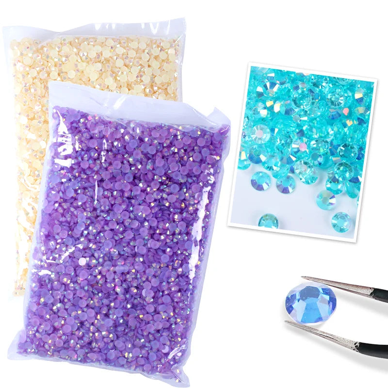 Bag of purple resin rhinestones and a bag of gold resin rhinestones with tweezers