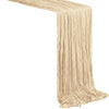 A beige semi-sheer gauze table runner with vertical pleats.