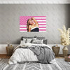Sabrina Carpenter American Flag tapestry featuring pink and white stripes and stars decorating a bedroom wall.