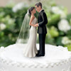 Elegant bride and groom wedding cake topper featuring a couple in formal attire