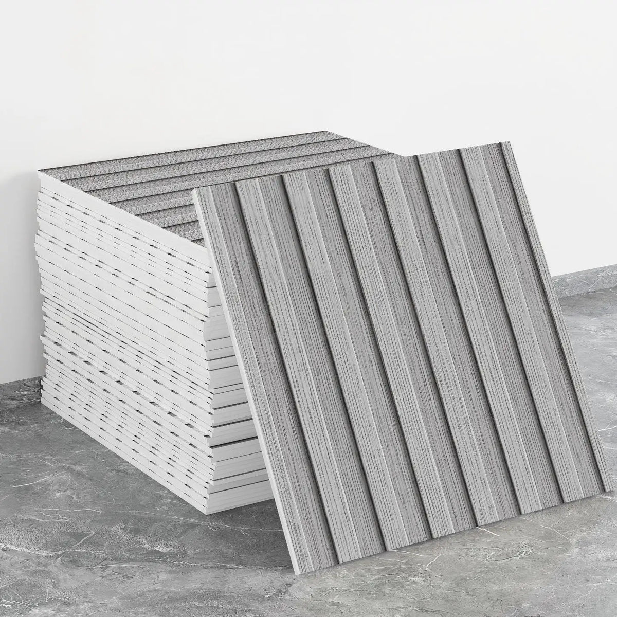 A stack of self-adhesive marble tile stickers in gray and white stripes on a concrete surface.