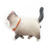 A small, gray and white 3D cartoon cat figure with an orange collar.