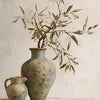 A ceramic vase holds olive branches against a light background.
