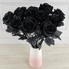 A bouquet of artificial black roses in a white vase on a light wooden surface.