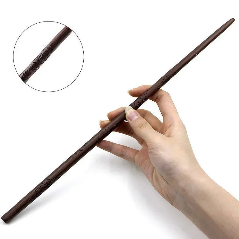A hand holds a dark brown metal-resin magic wand with a textured grip, demonstrating its size and shape.