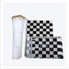 A set of black and white checkered flags and a white pleated fan for a birthday racing car party decoration.