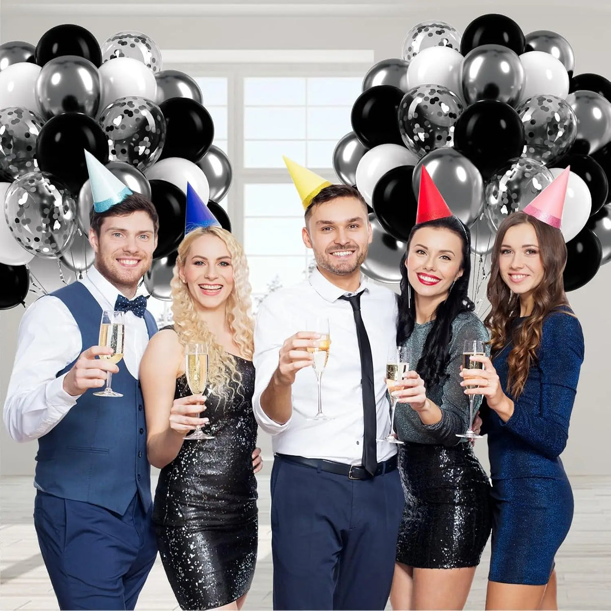 Five models posing with an elegant black and silver balloon kit for event decor