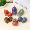 A collection of natural crystal cat statues in various colors including red purple green and blue on a light background.