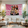A pink and white striped tapestry featuring five women in K-Pop inspired outfits hanging on a wall.