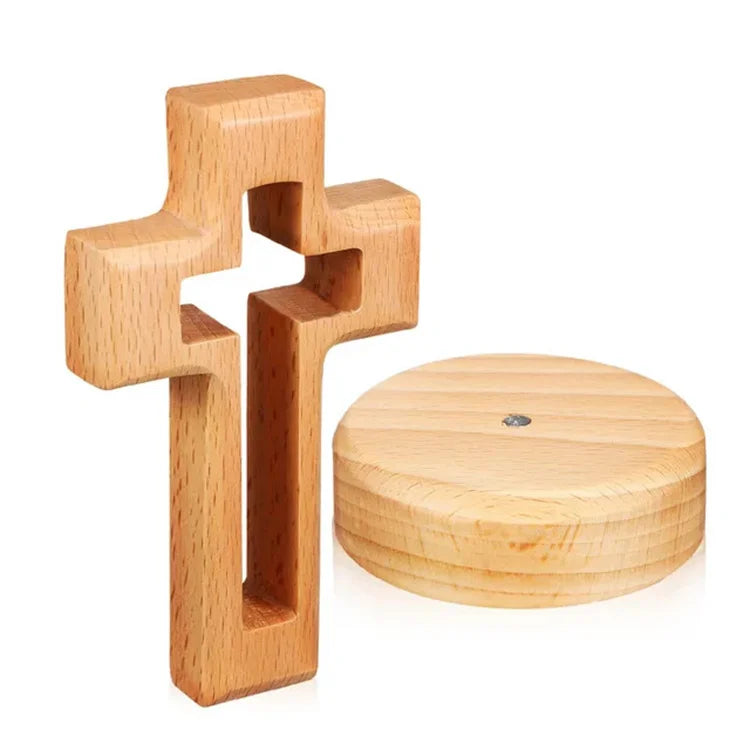 A light wood crucifix wall ornament with a cross shape and a round base.