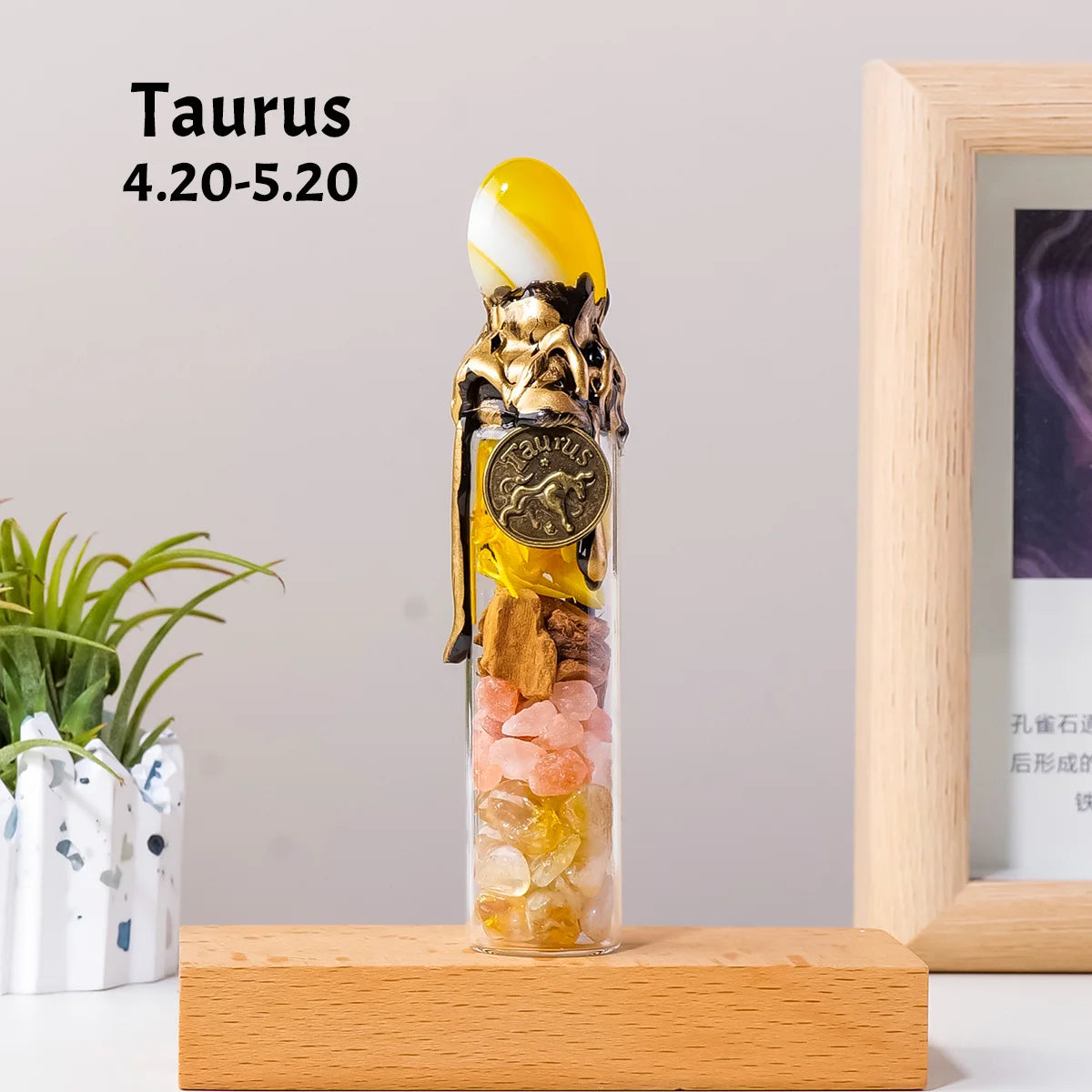 A glass bottle filled with yellow and amber crystals, topped with a gold coin, displayed on a wooden surface.