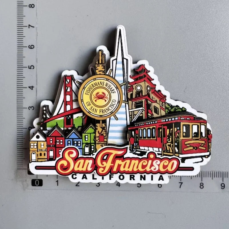 A collection of wooden fridge magnets depicting San Francisco landmarks including the Golden Gate Bridge, Victorian houses, a