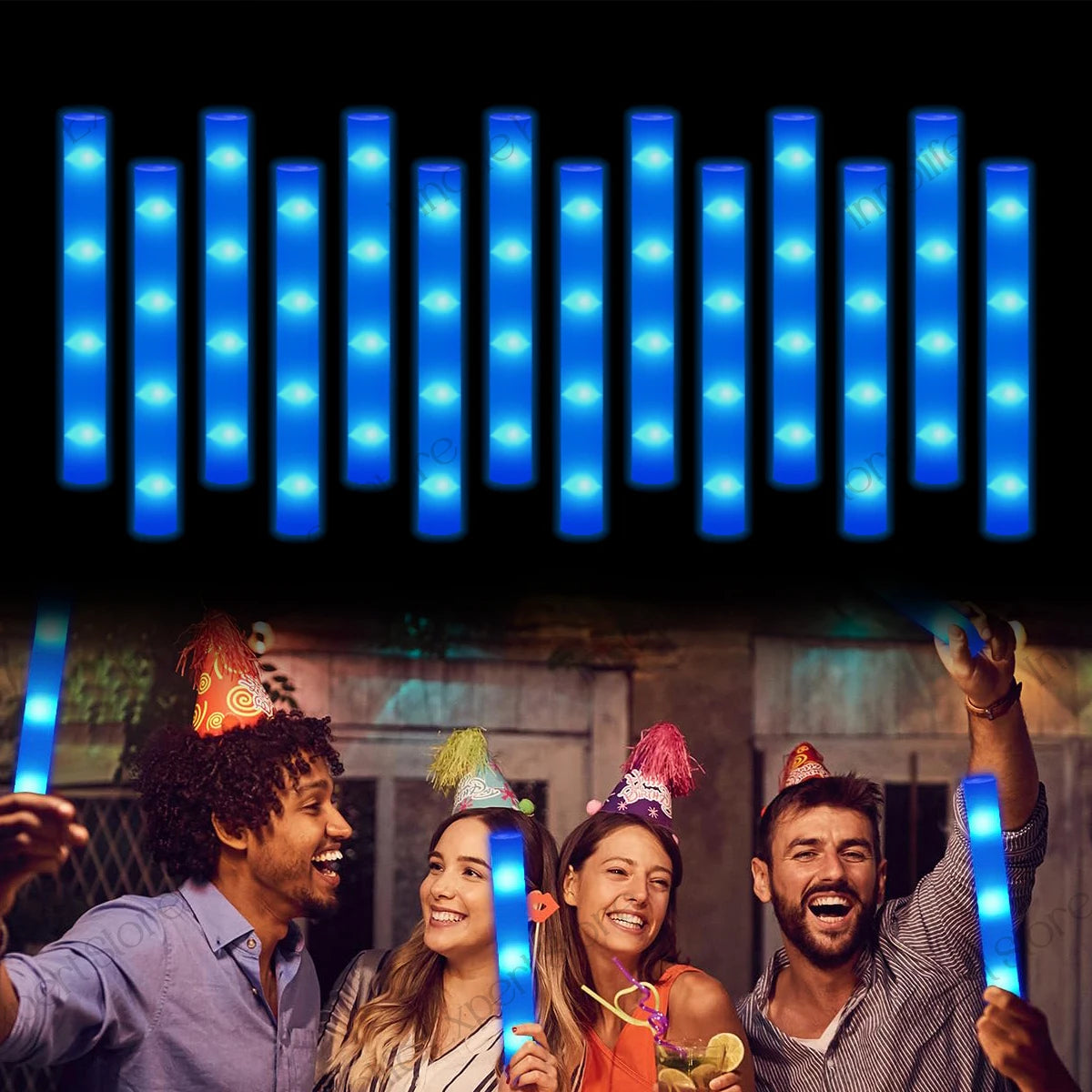 A group of four people are holding and using LED foam glow sticks in a dark setting.
