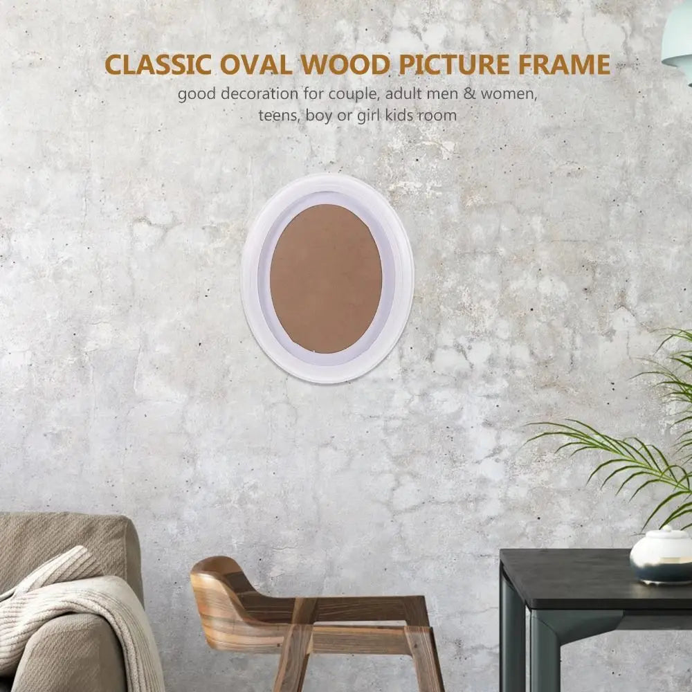 A classic oval wood picture frame in a matte brown color displayed on a gray textured wall.