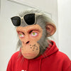 A realistic chimpanzee latex mask with gray fur and a red hoodie wearing sunglasses.
