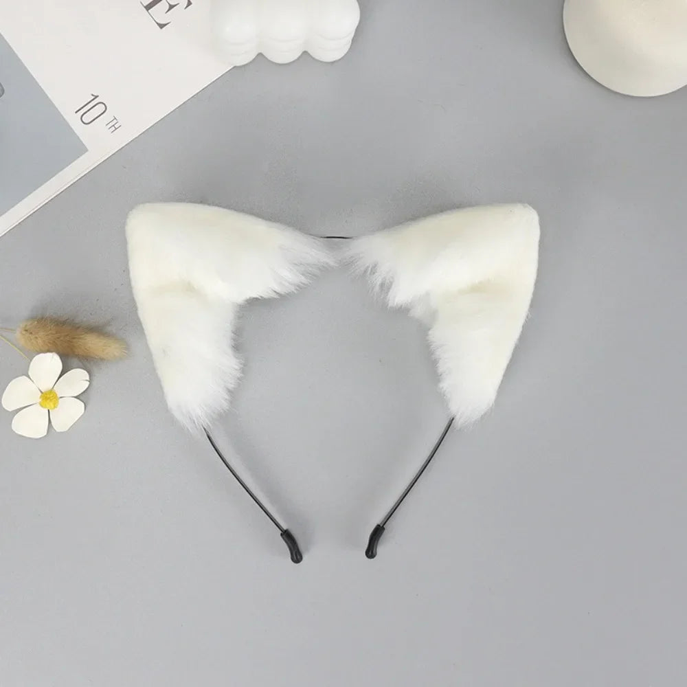 A white plush fox ears headband with black nose wires is displayed on a gray surface.