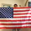 A large American flag made of double-sided polyester is displayed indoors.