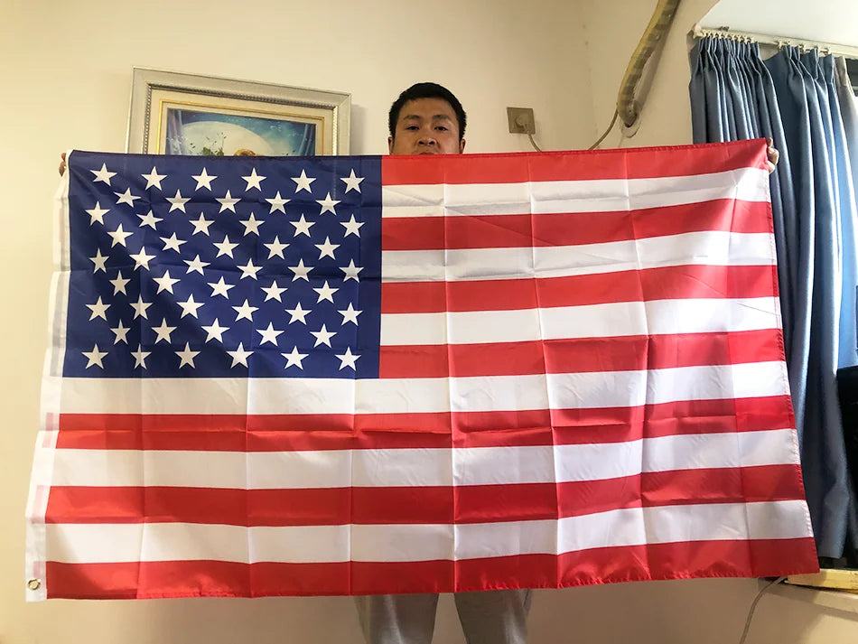 A large American flag made of double-sided polyester is displayed indoors.