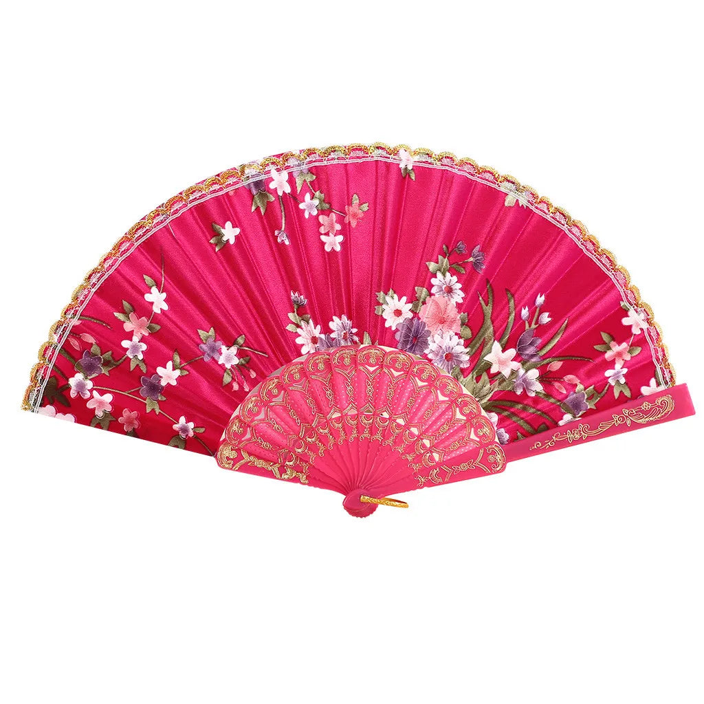 A vibrant pink hand fan with floral embroidery and gold trim.