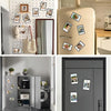 A collection of magnetic mini photo frames displayed on a light-colored cabinet and a dark gray door.