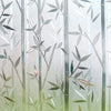 Frosted window privacy film featuring delicate green leaves and vertical light patterns.