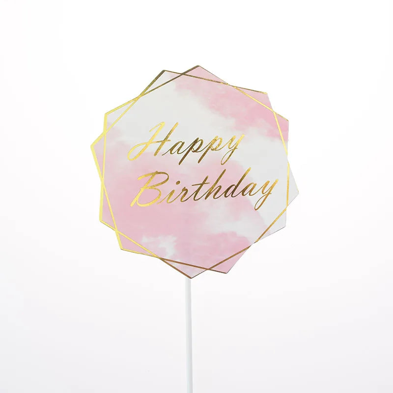 A pink watercolor hexagon flag with gold text that reads Happy Birthday