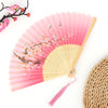 Pink and white floral patterned vintage bamboo folding fan with light pink fabric