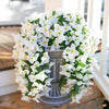 A lush white artificial bougainvillea vine garland displayed in a silver urn for home or wedding decor.