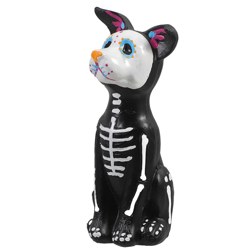 A black resin figurine of a dog and cat with white facial markings and pink accents.