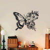 Black metal butterfly wall decor featuring an intricate floral pattern mounted on a light-colored wall.