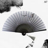 A hand carved bamboo folding fan with gray stripes and silver accents, shown open against a white background.