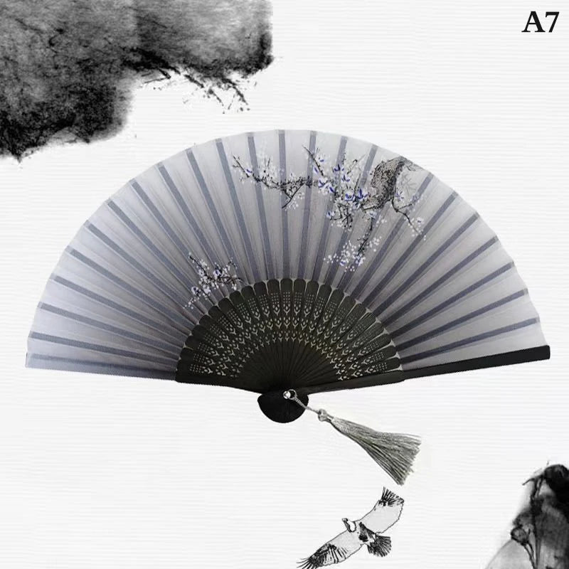 A hand carved bamboo folding fan with gray stripes and silver accents, shown open against a white background.