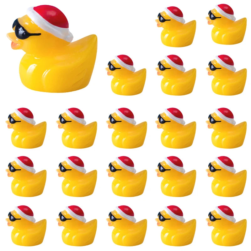 A set of glow-in-the-dark Christmas duck figurines wearing Santa hats.