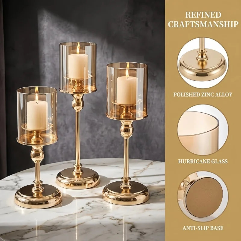 Three gold-toned pillar candle holders with glass and anti-slip bases displayed on a white marble surface.