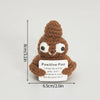 A handmade crochet positive potato doll with a brown textured body and white eyes, featuring an inspirational slogan on the t