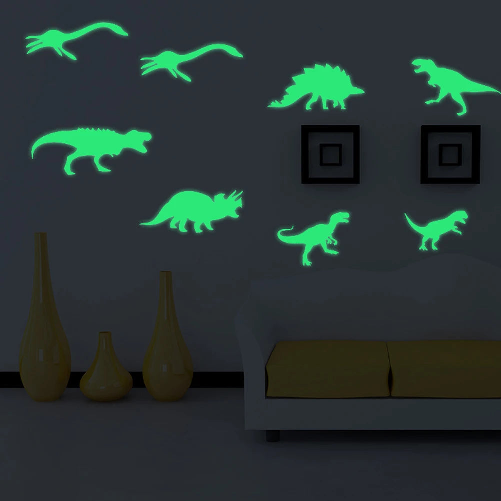 A wall display featuring glowing green dinosaur silhouettes on a gray wall above a sofa and decorative vases.