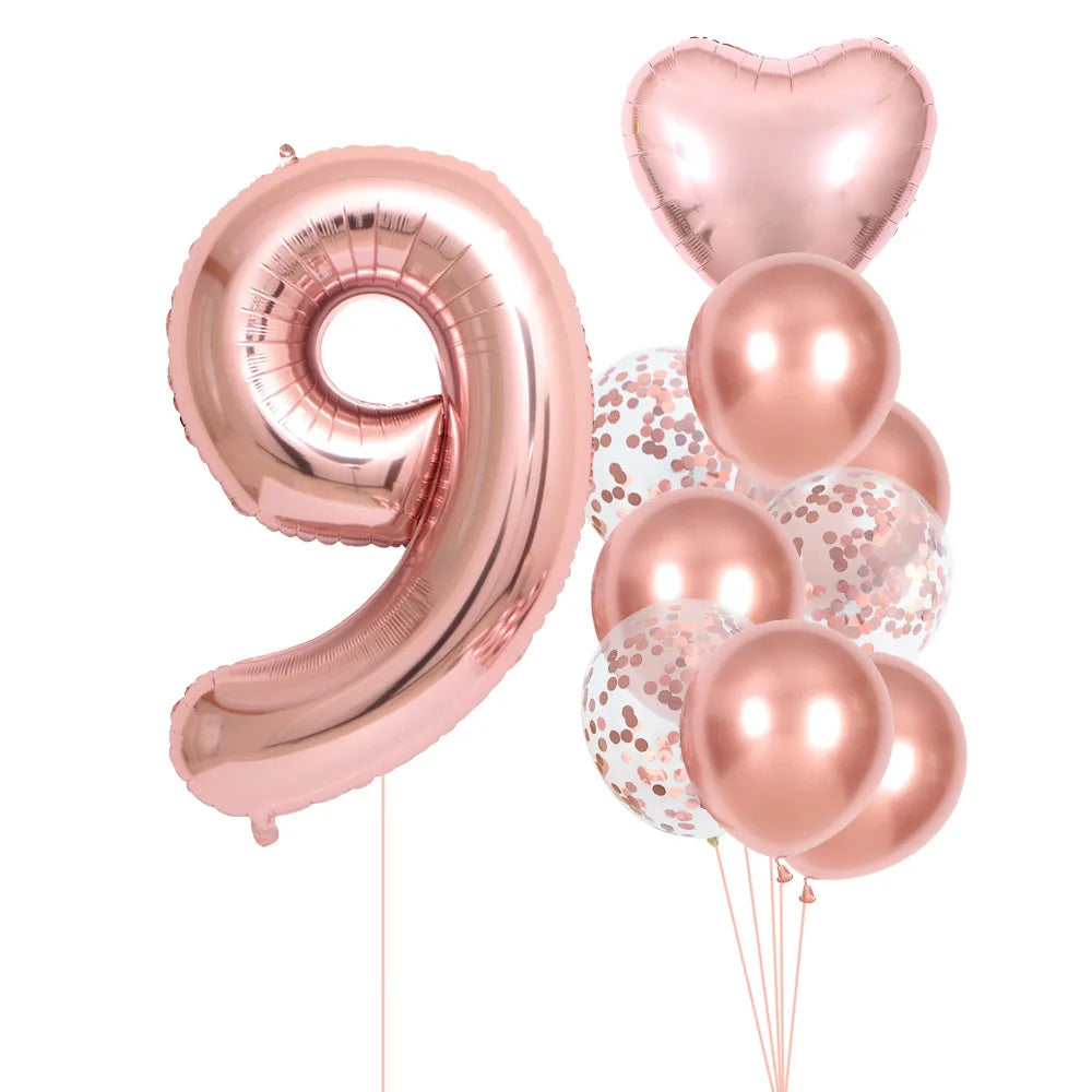 A set of rose gold foil balloons shaped like the number 9 and several round balloons for party decoration