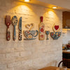 A set of seven rustic wooden kitchen decor pieces including a fork, spoon, knife, teacup, and wine glass displayed on a white