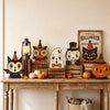 A collection of retro wooden block Halloween decor including a lantern, owl, Jack Skellington, and pumpkin figures.