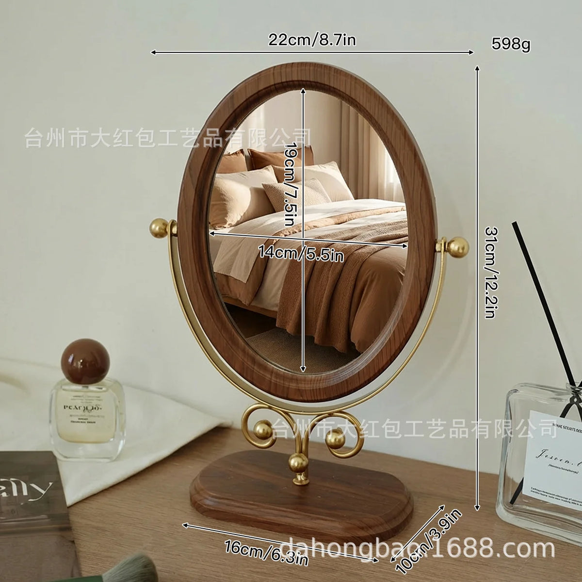 A round wooden vanity mirror with a gold frame and a rotating oval mirror surface.