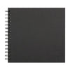 A black spiral-bound notebook or scrapbook album with metal rings on the left edge.