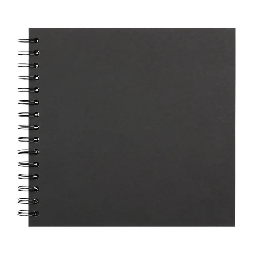 A black spiral-bound notebook or scrapbook album with metal rings on the left edge.