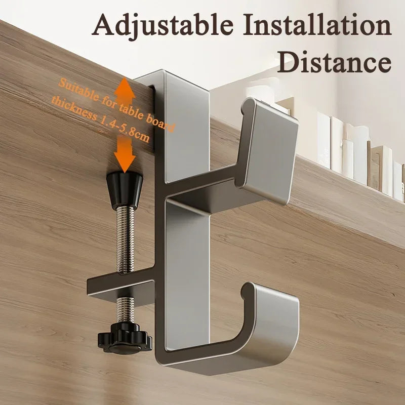 A silver adjustable desk bag hook installed on a wooden surface, demonstrating suitable installation distance for table board