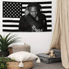 A black and white tapestry banner featuring a portrait of a person with dreadlocks against an American flag background.