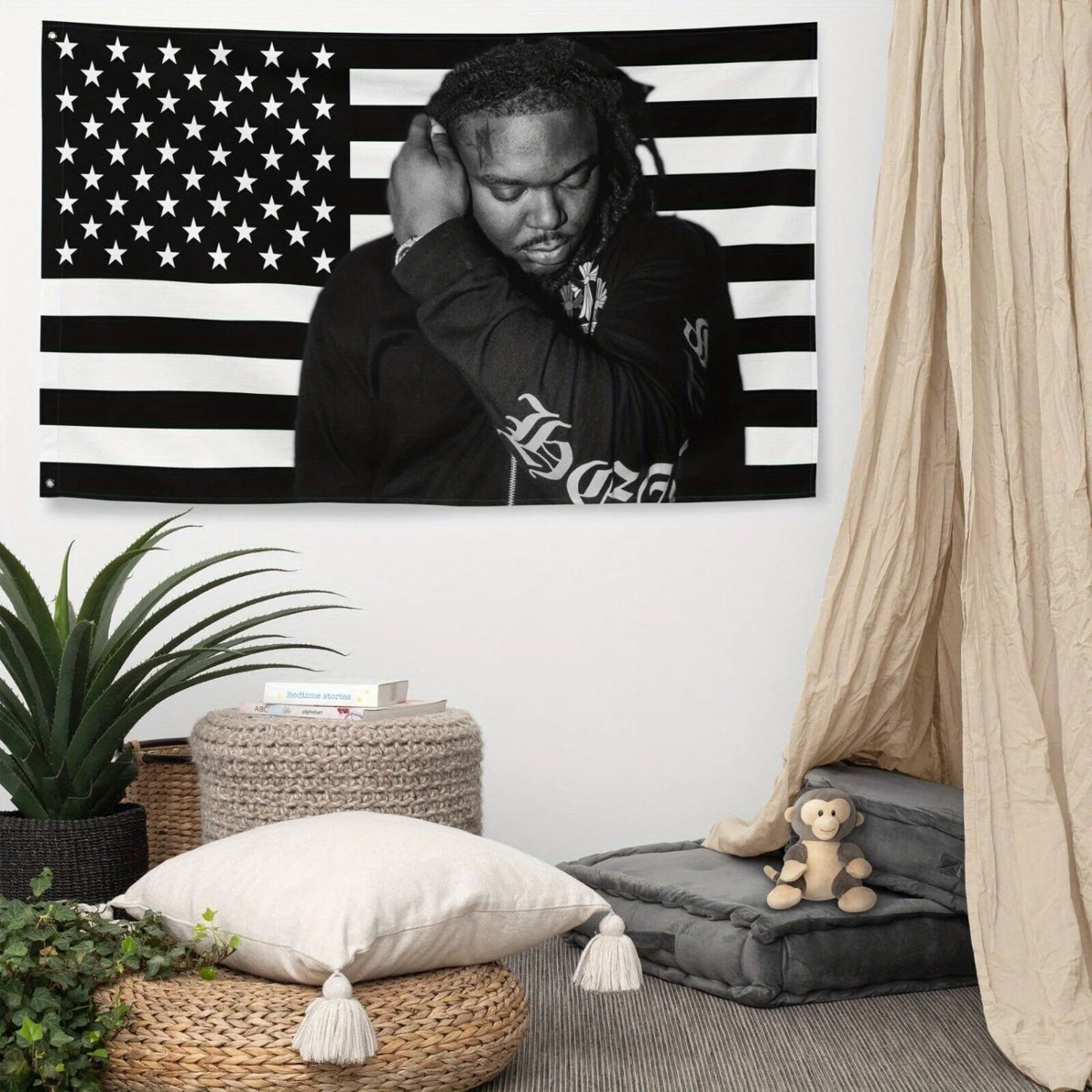 A black and white tapestry banner featuring a portrait of a person with dreadlocks against an American flag background.