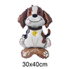 A foil balloon shaped like a dog's head with brown ears and white body, sitting on a brown base.