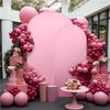 A pink balloon arch backdrop cover featuring various shades of pink balloons and floral accents.